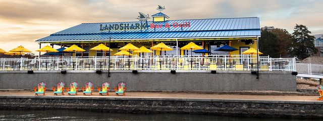 Exterior deck with tables and umbrellas on the water