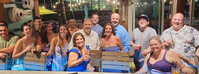 Group of friends sharing drinks and laughs at Margaritaville Paradise Island Bahamas