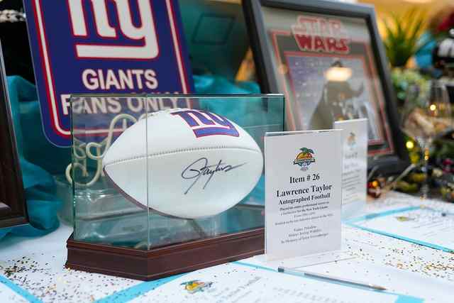 Items for auction including New York Giants football and Star Wars memorabilia