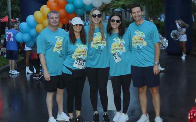 A runner giving high fives to 4 other people