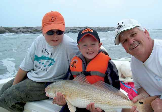 Mark Ritchie, Chase Ritchie, and step father, Mark Sexton Port O'Connorunique red with a heart shaped spot, caught and released