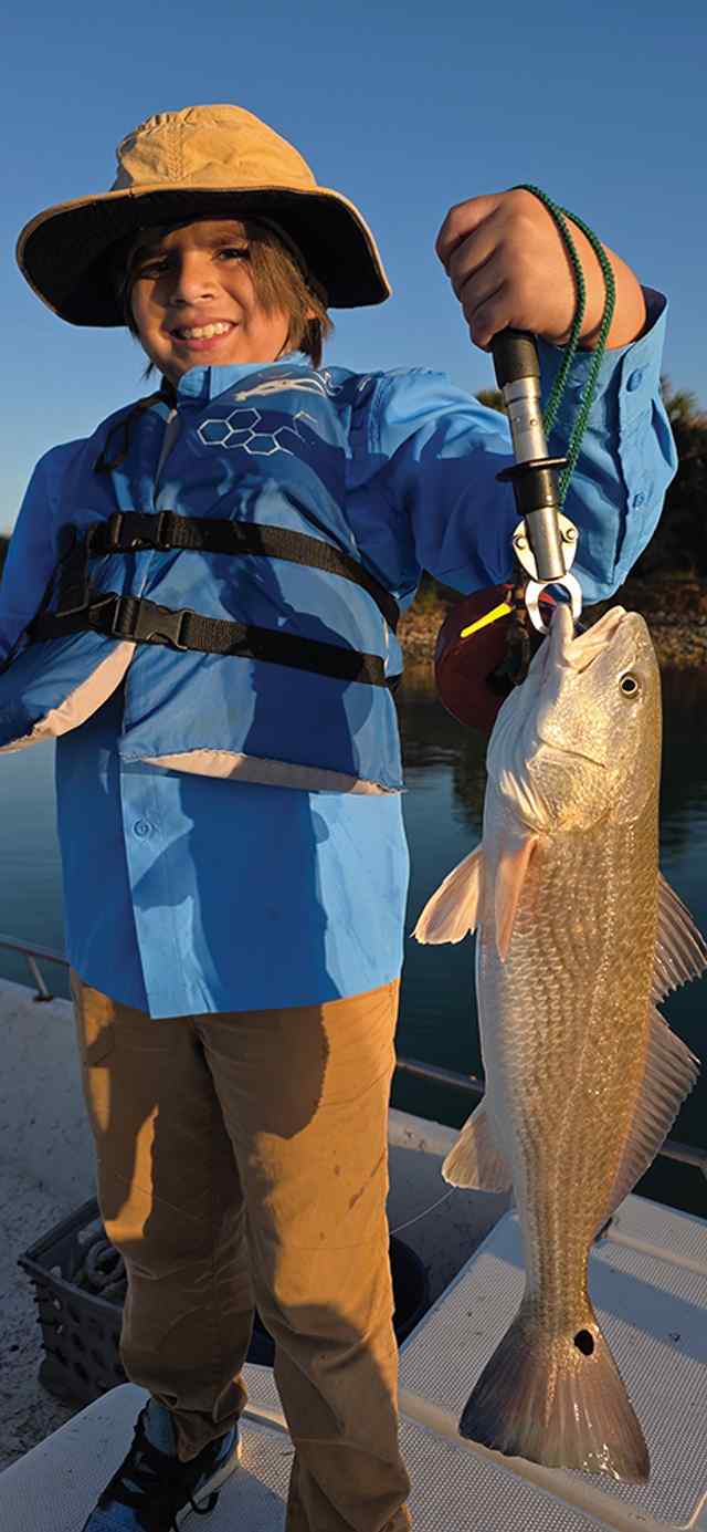 Bryton Kyrisch 21" redfish, caught while fishing with his great gramps & grandpa