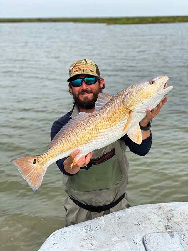 Jody Haines POC - 30" 11lb redfish CPR, caught on a spook Jr. Bone in shin deep water over grass pockets and mud