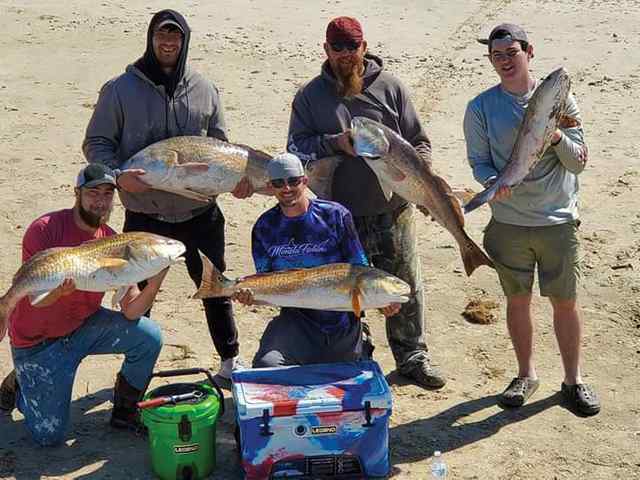 Bobby Hall put these first-time saltwater anglers on bull reds (Bolivar Peninsula)