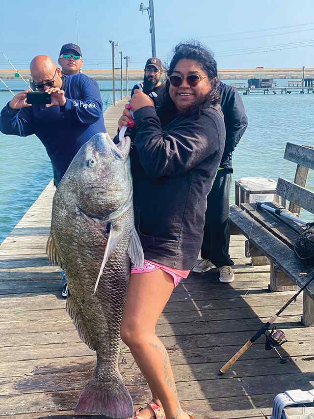 Beatrice Becerra Red Dot Fishing Pier (Corpus Christi) - 47" black drum, caught on Penn Battle III 4,000 series real and pink camo 30lb spider wire braid, with dead shrimp and crab fish bites - lifelong dream!