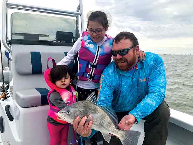 Carly Latham Baffin Bay - 15" first fish! (black drum) - caught on a K wiggler under a popping cork while fishing with her sister DenI