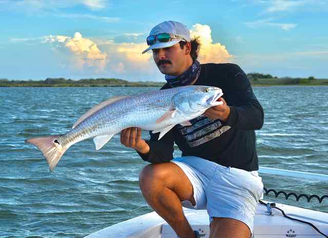 Noah Elizondo redfish, caught on a 5" pearl/white DOA, drifting night hawk