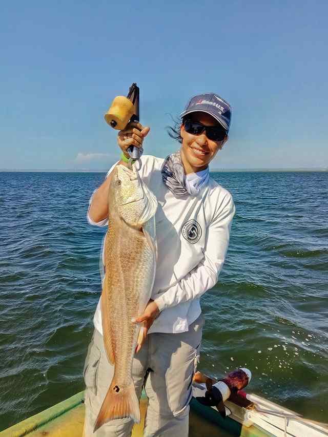Lydia Escochea Yellow Cabin - 30" first redfish! caught under cork