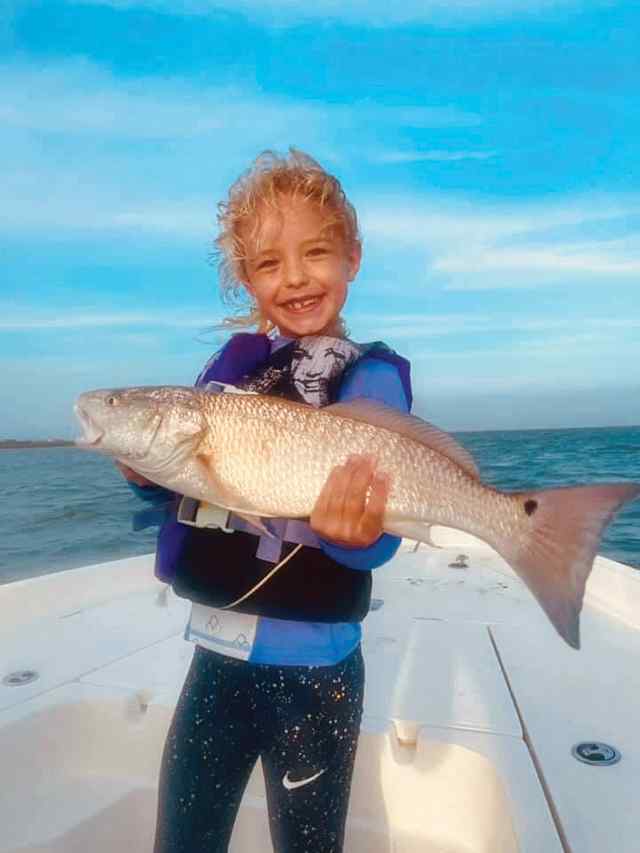 Ellie Vesely Port O'Connor - 24" first redfish! Fishing with her cousin, Scott Lesak and his dad, Kyle Lesak