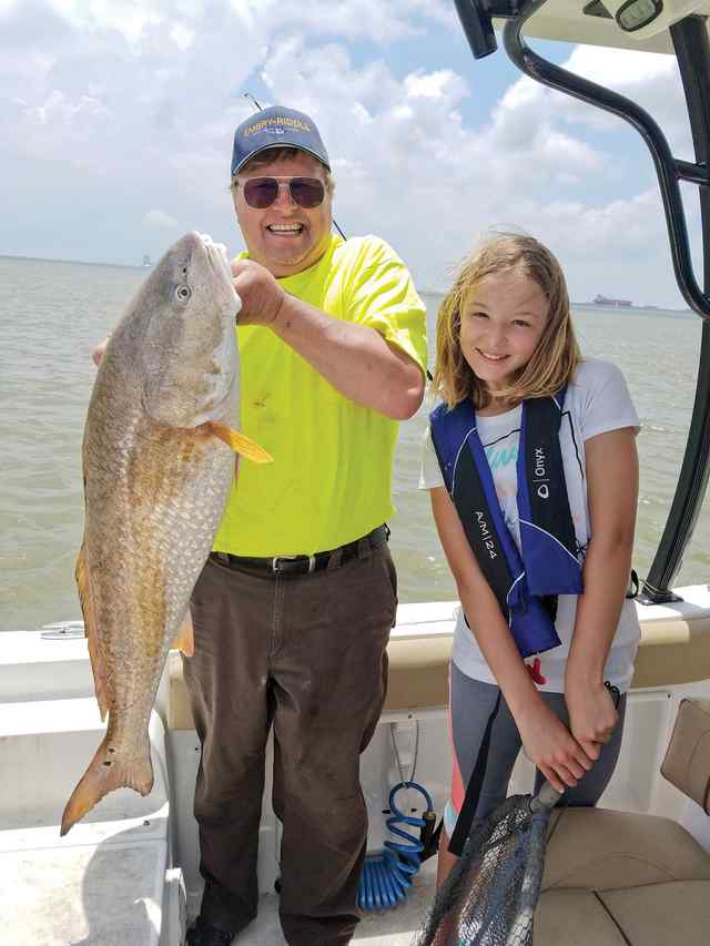 Grandpa Mike & Reagan Galveston jetties - 40" first redfish! CPR