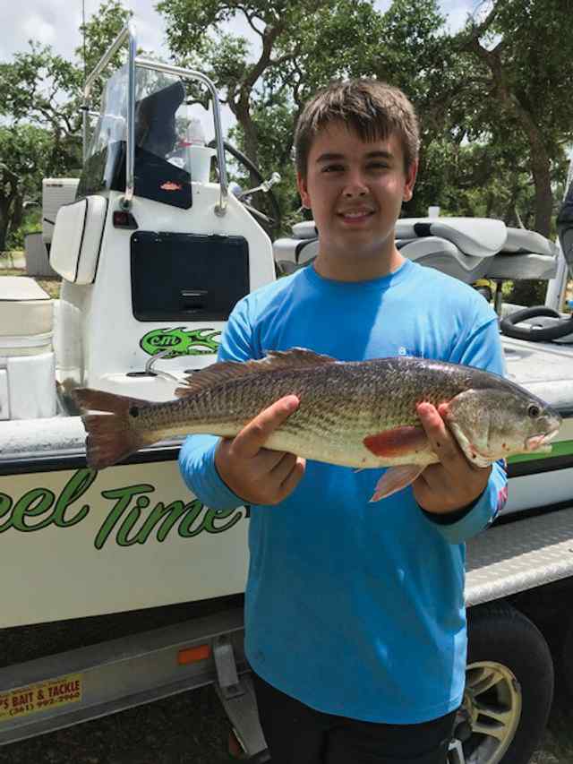 Nicholas Beuershausen St. Charles Bay - first redfish! Caught while fishing with his dad, Christopher, and grandfather, Barry.