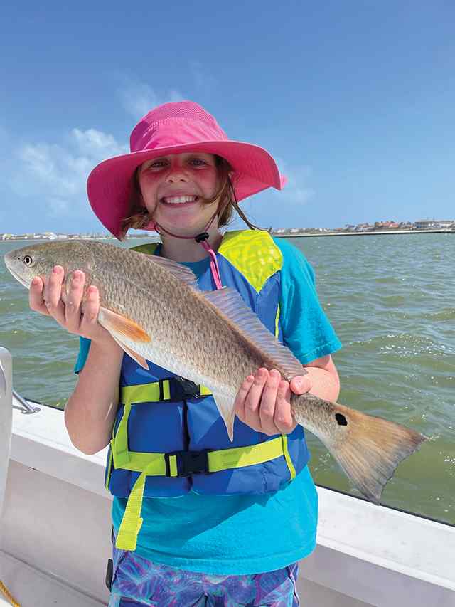 Winnie Forrester Packery Channel, North Padre Island - 21.5" red, using live shrimp and expert guiding from her dad, Matt Forrester