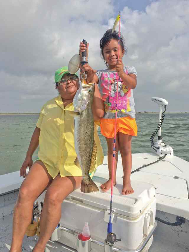 Kylie first keeper trout! (with Mom's help)