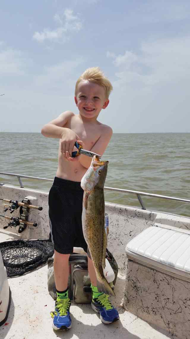 Devyn Ritter East Galveston Bay21&quot; personal best trout!Fishing with Mom, Dad, and brother. He was using an artificial sea shad. Next trout was mauled by a 4ft shark and spooled his reel. Exciting day for him!