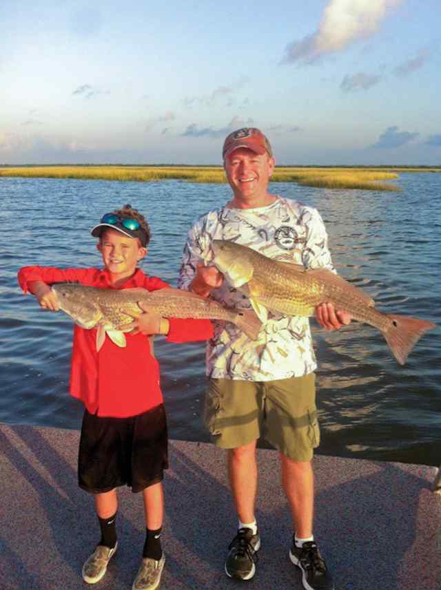 Ethan & Jeremy Doyle Matagorda - matching 31" redfish CPR, hooked up at the same time.