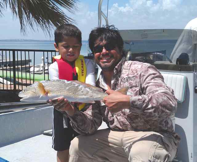 Marcus Gaspar & dad South Padre24&quot; first redfish!