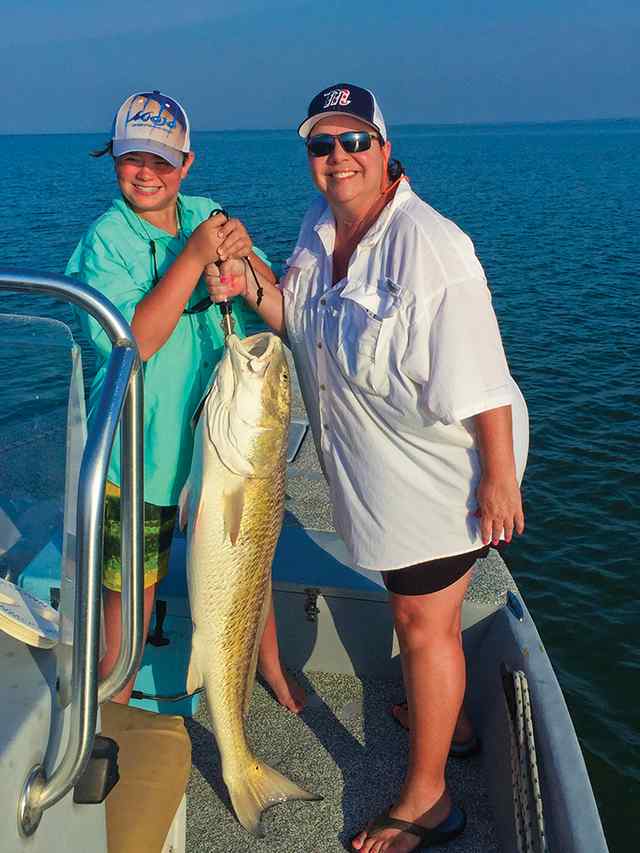 Therese Vickery Baffin Bay - 49" personal best red! CPR - with a little help from Brayden Vickery to hold it up