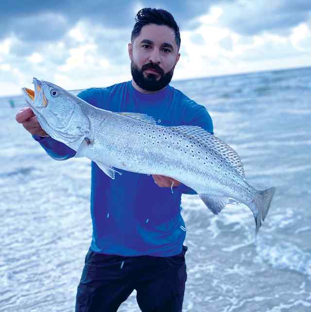 Israel Gomez 25.5" trout CPR, caught on live croaker while surf fishing