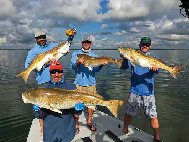Front: Pat Schuchart. Back (left to right): Brent Beauchamp, Raymond Avery Sr, Shane Schuchart North Padre - redfish, hooked simultaneously