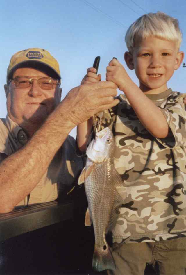 Austin Thompson and Grandpa Rusty Thompson Austin's first redfish!