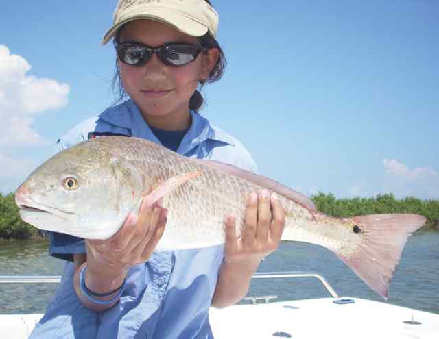 Mary Hakala 
  showing how she reels them in during the Texas Redfish Series