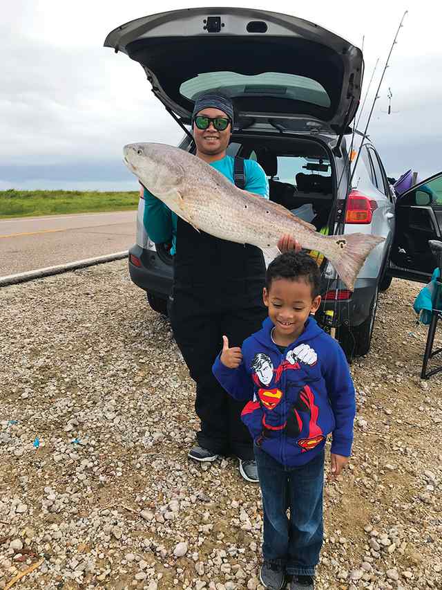 Danielle Khampannha Texas City Dike - 40" bull red CPR, caught on light tackle (son giving thumbs up for the great catch)