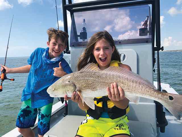 Whitley Blackburn with brother, Thomas Port O'Connor surf - 29" redfish