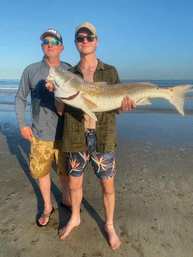 Garrett Johnson with father, Mike Bolivar Peninsula surf - 39.5" first bull red!