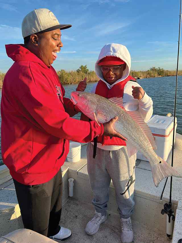 JD Martin with father, Darryl Matagorda Bay - 34" redfish