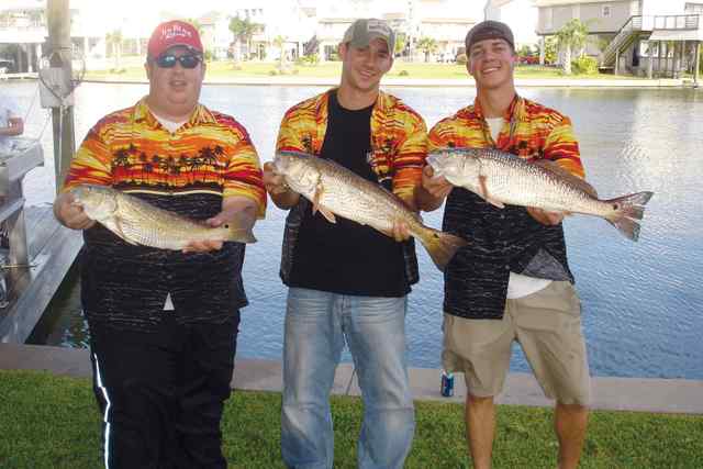 Justin Tankersley, Lane Butters, and Will Dillard proudly displaying their matching reds and shirts