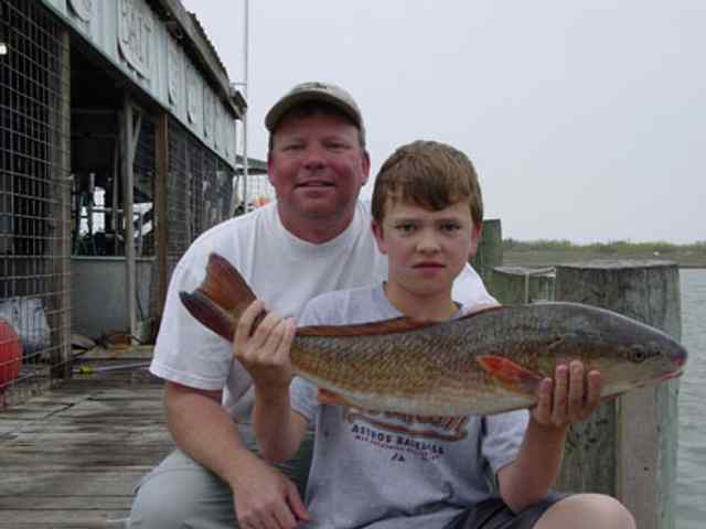 Reid Wheatley with father Port O'Connor27.5&quot; red, first wading trip!