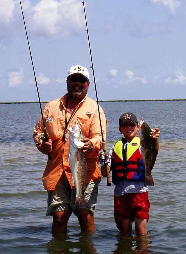 Rick Ulrich and son Bronson Ulrich showing off their catches from a father and son bonding wade trip