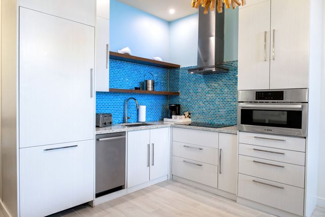 241112-MVNassauBeachResort-OPH-9165.jpg Fully equipped kitchen with modern appliances and white cabinetry